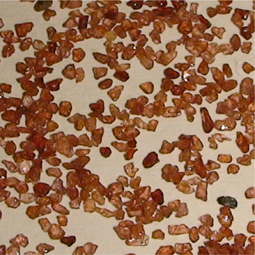 Close view of reddish-brown garnet abrasive grains